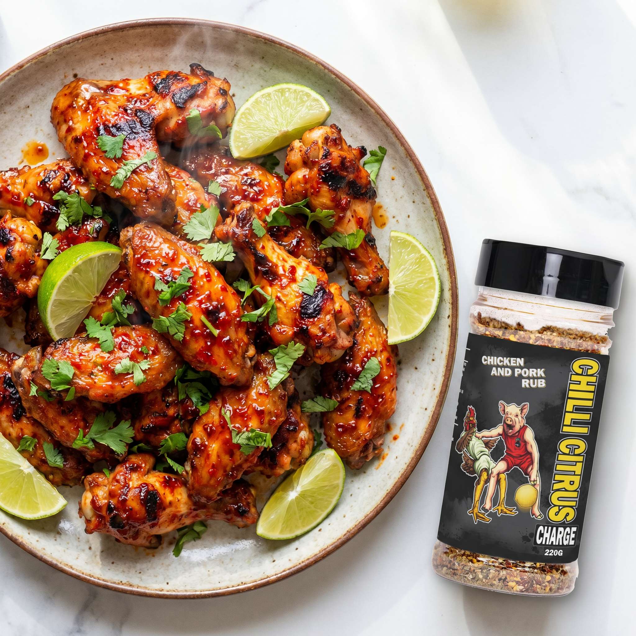 Low n Slow Basics Chilli Citrus Charge rub — grilled chicken wings in a chilli-citrus glaze with lime wedges