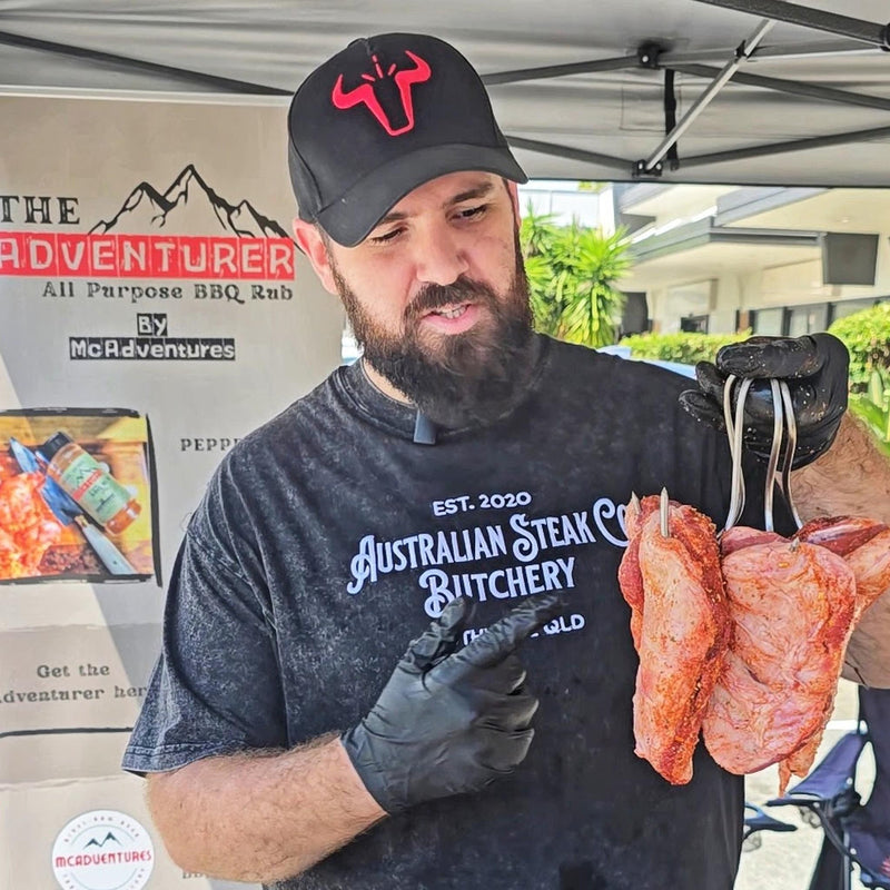 Lachlan, founder of McAdventures, running an Adventurer BBQ Rub demo at a live market stall lifestyle photo