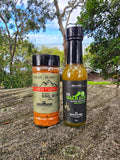 McAdventures The Expedition Pack — Adventurer rub and Trailblazer sauce together on coastal rock — lifestyle