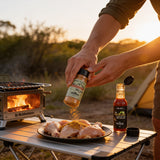 McAdventures The Expedition Pack being used at an outdoor camp table, seasoning chicken with both products, in-use lifestyle