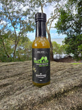 McAdventures The Trailblazer Sweet Chilli Sauce 150ml bottle on coastal rock — lifestyle