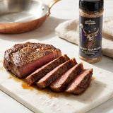 Middle Kingdom Beef Baron 165g beef seasoning — sliced reverse-seared ribeye with a dark coffee crust and rosy interior on marble