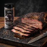 Middle Kingdom Beef Berserker 170g steak and brisket seasoning — smoked beef brisket slices with a dark peppery bark and smoke ring on a timber board