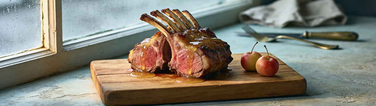 Mitch's Preserves Crab Apple Jelly: Rack of lamb glazed with crab apple jelly beside crab apples at a rainy window