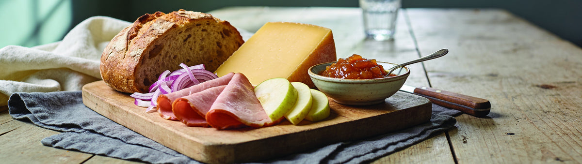 Mitch's Preserves Tomato Chutney: Ploughman's board with bread, cheddar, ham, apple and tomato chutney