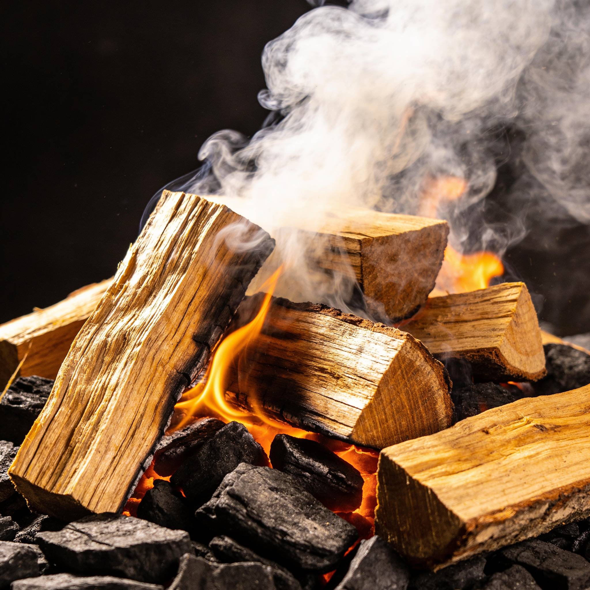 Natural Smoke Aussie Oak wood chunks smoking on hot coals