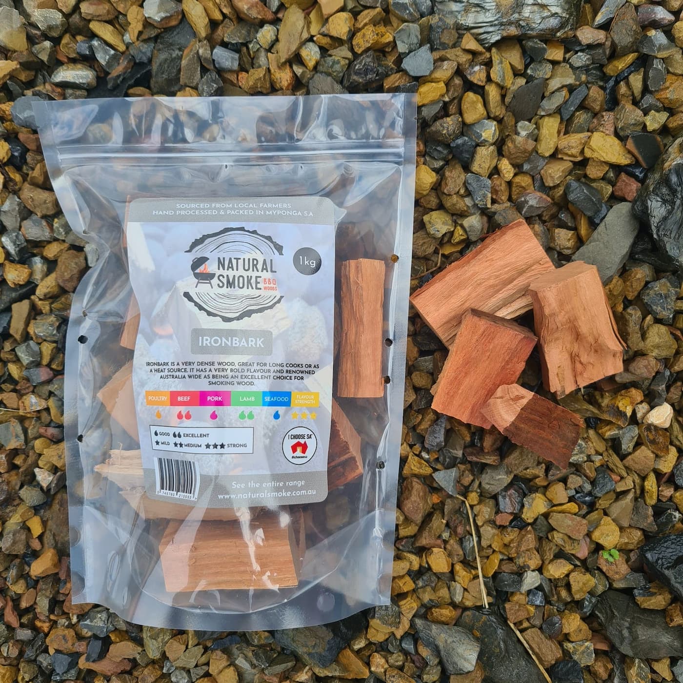 Natural Smoke BBQ Woods Ironbark wood chunks 1kg bag on location with raw wood chunks