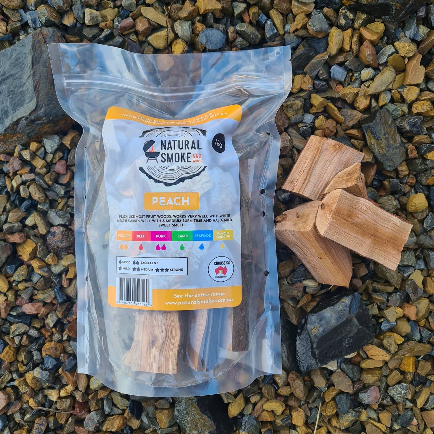 Natural Smoke BBQ Woods Peach wood chunks 1kg bag on location with raw wood chunks