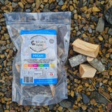 Natural Smoke BBQ Woods Pecan wood chunks 1kg bag on location with raw wood chunks