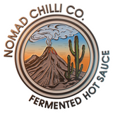 Nomad Chilli Co brand logo, erupting volcano and cactus desert roundel, fermented hot sauce, on transparent background