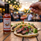 Nomad Chilli Co Habanero Roja hot sauce — carne asada steak tacos with red habanero sauce spooned over at a taqueria