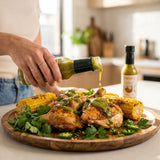 Nomad Chilli Co Jalapeño Verde hot sauce — green verde sauce over roast chicken and charred corn