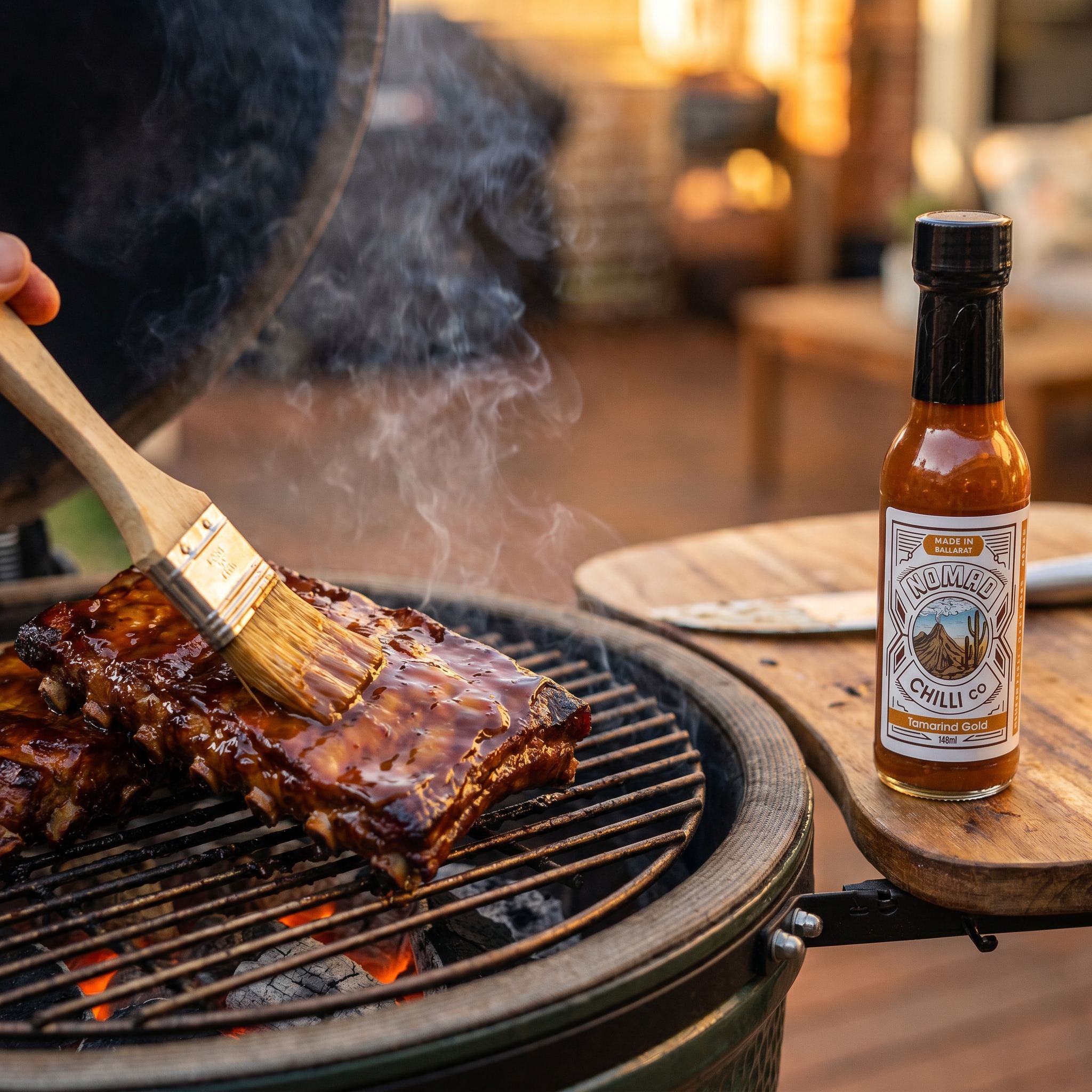 Nomad Chilli Co Tamarind Gold hot sauce — pork ribs glazed with tamarind on a kamado grill