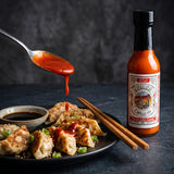 Nomad Chilli Co The Sriracha Sauce — red sriracha spooned over pan-fried gyoza dumplings
