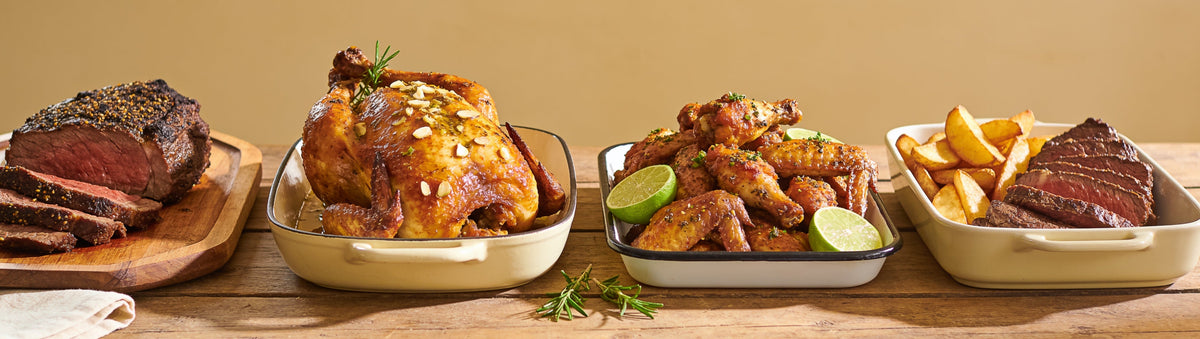 Outlaw Barbecue four pack rub bundle with brisket, roast chicken, lime wings and steak laid out on a long timber table