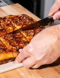 Pizza Czar by Anthony Falco hardback cookbook — Sicilian-style pepperoni pizza being sliced