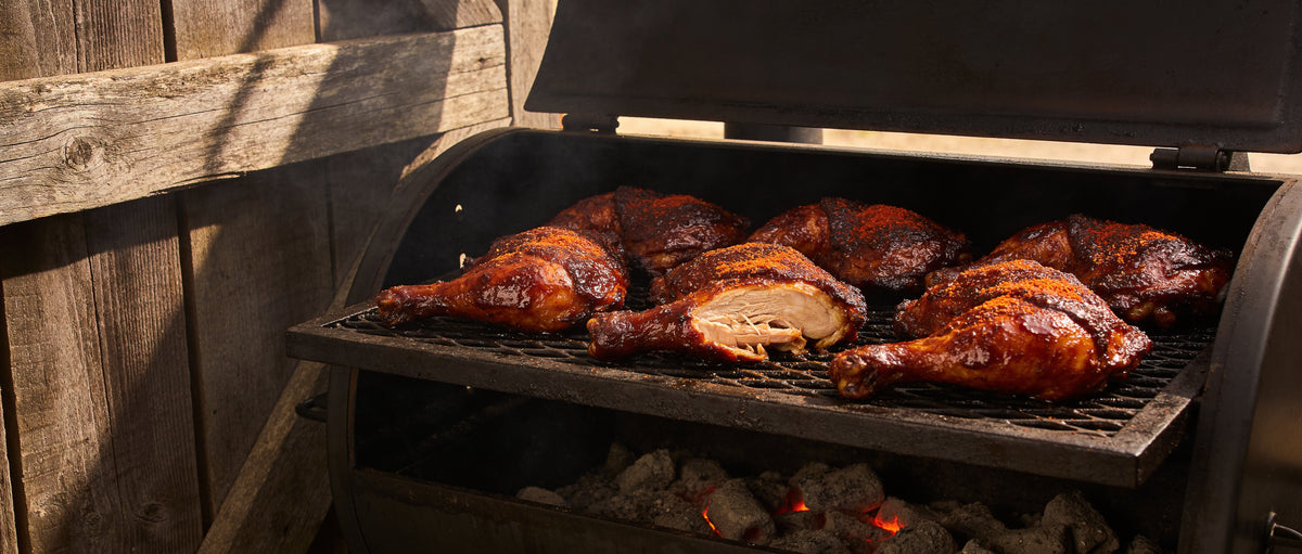 Plowboys BBQ Yardbird Rub with smoked chicken thighs on a Kansas City smoker grate