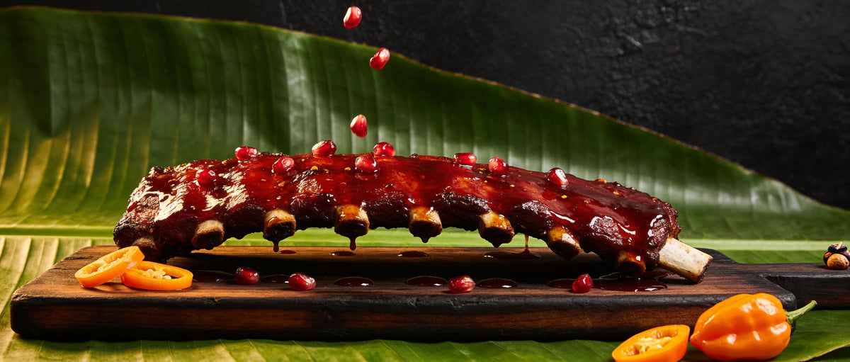 Four Monkeys BBQ Jungle Juice Pomegranate Habanero glaze dripping off sticky pork ribs