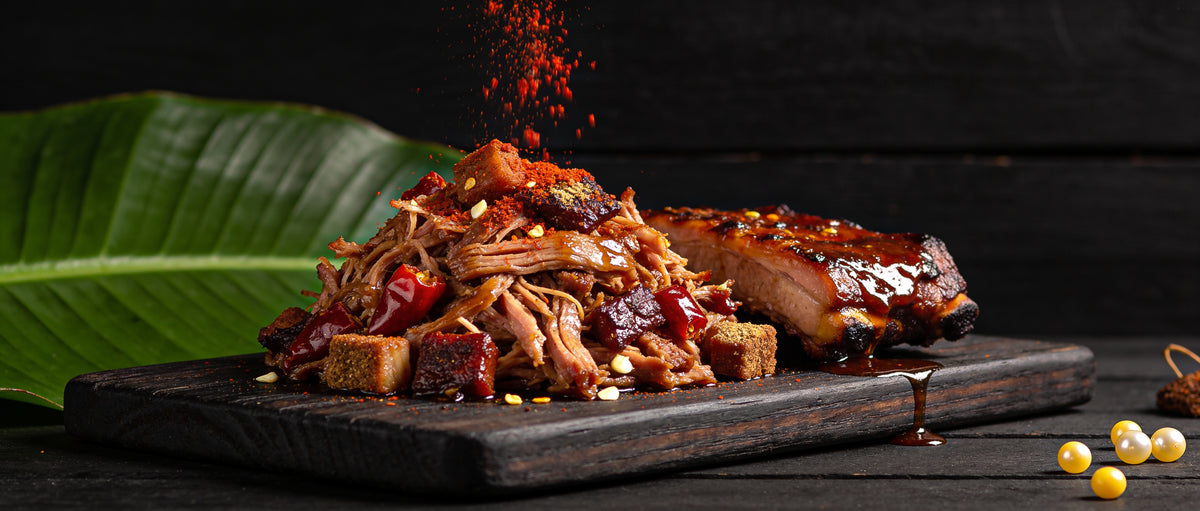 Four Monkeys BBQ Pork Rub paprika bark on moist glistening pulled pork