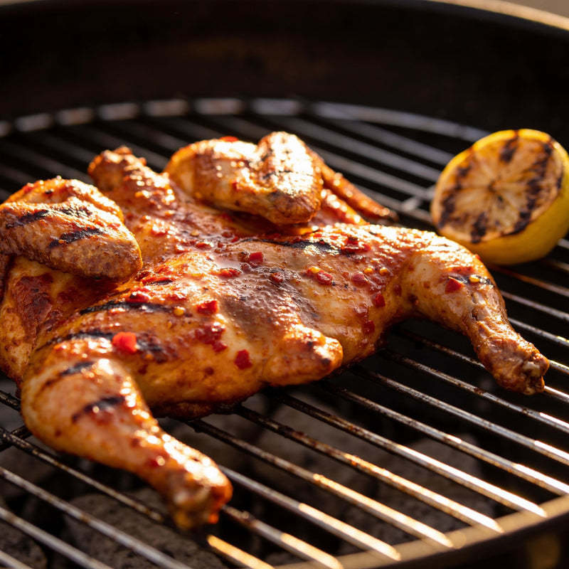Portuguese-style peri peri grilled chicken, char-grilled with glossy chilli-garlic baste lifestyle photo