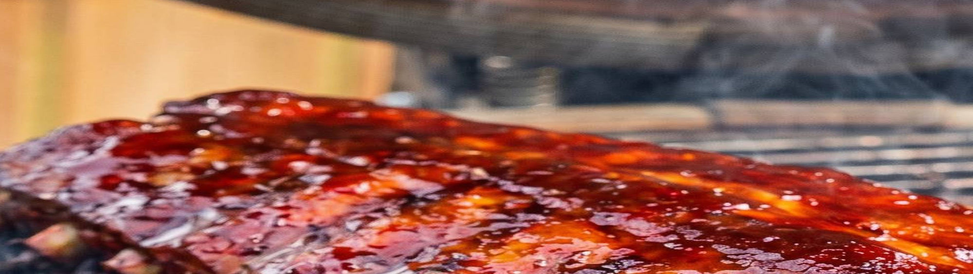 Smokes Seasoning Cherry Chipotle BBQ Rub beside glazed pork ribs glistening on the smoker, sweet cherry chipotle barbecue rub