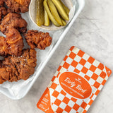 Rum and Que Dirty Bird Nashville coating — crispy fried chicken with pickles and the pack alongside