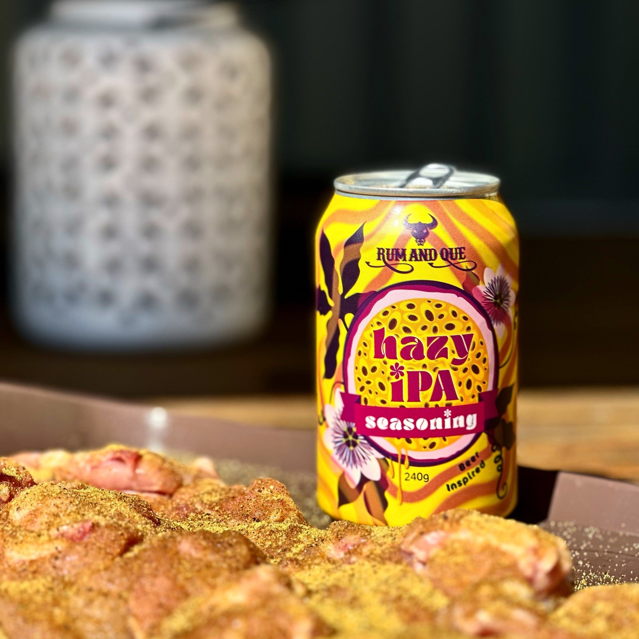 Rum and Que Hazy IPA beer rub can with seasoned chicken cooking alongside