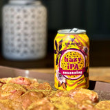 Rum and Que Hazy IPA beer rub can with seasoned chicken cooking alongside