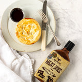 Rum and Que Meat Juice BBQ sauce — golden pie served with a dish of the sauce, bottle alongside