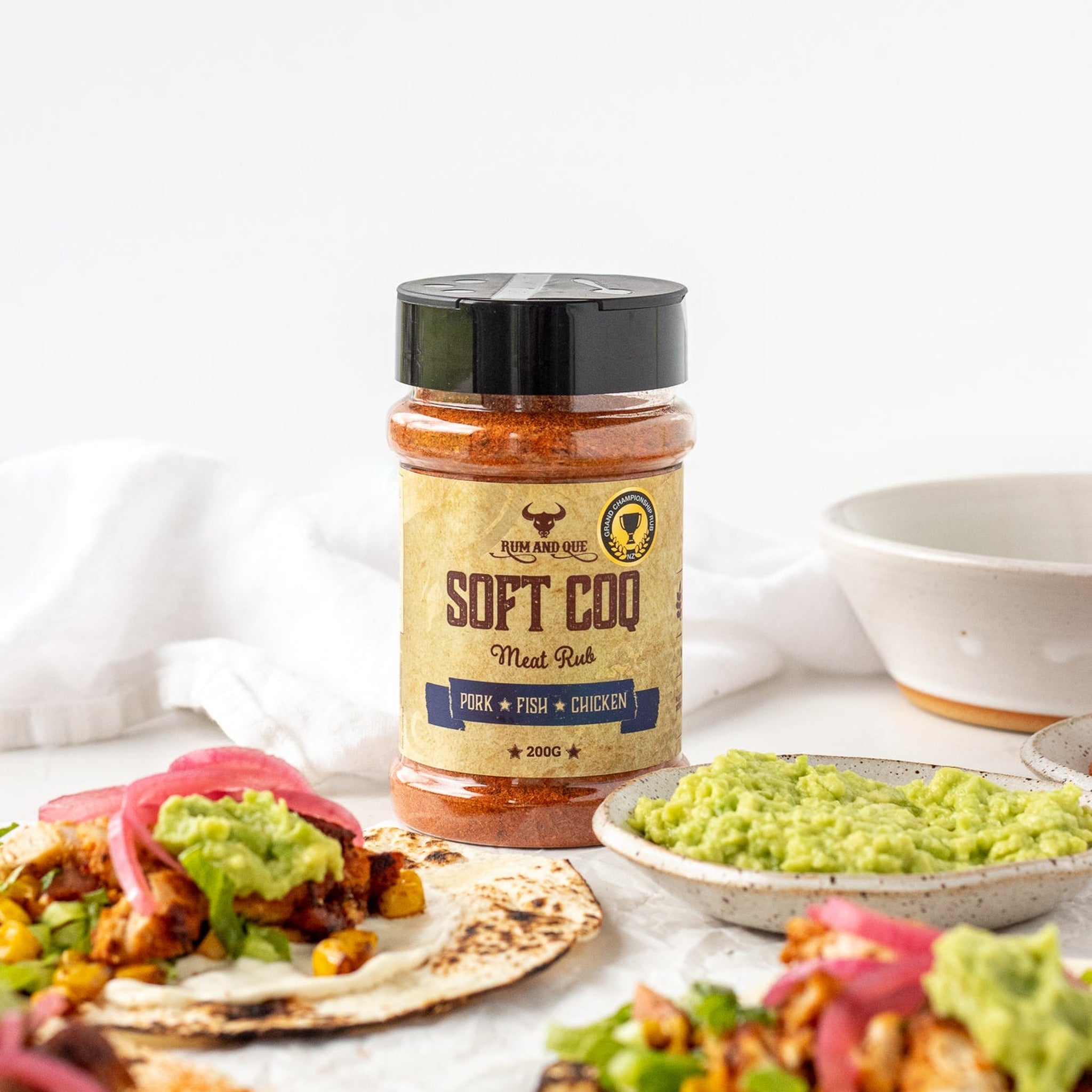 Rum and Que Soft Coq rub — chicken tacos with guacamole and pickled onion, shaker alongside