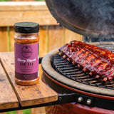 Smokes Cherry Chipotle BBQ rub — pork ribs with a glossy ruby-red bark on a kamado grill