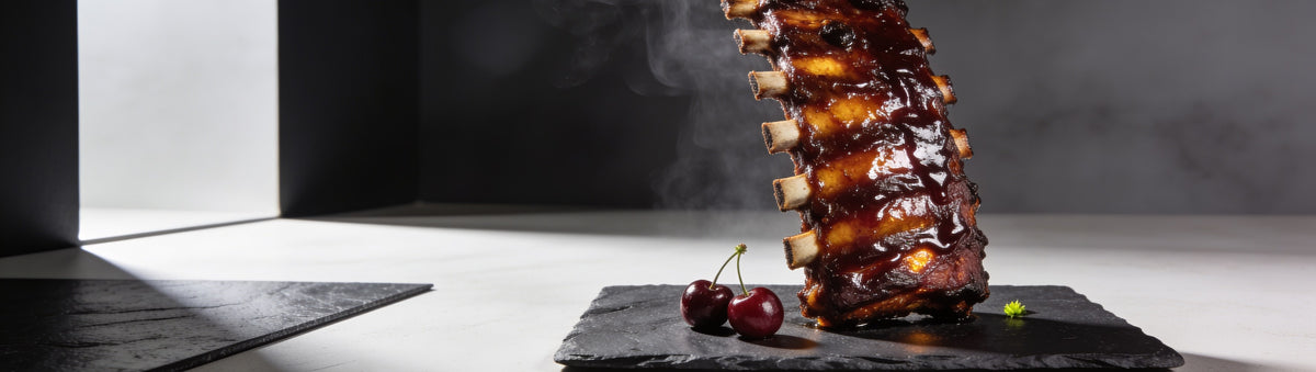 SinsQue Grunt Cherry Pork Rub 250g pork rub — glossy cherry-glazed ribs with product shaker over open fire