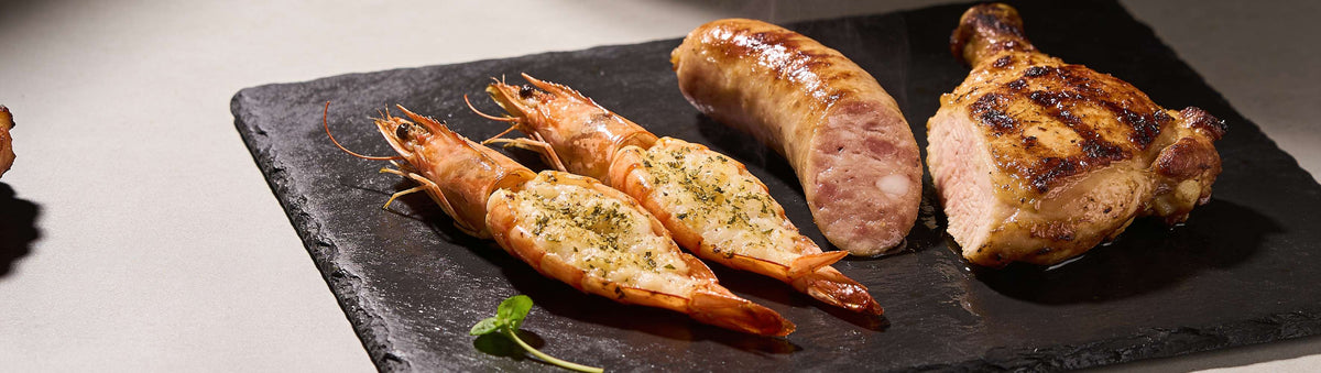 SinsQue Snow All Purpose Rub 250g rub — grilled snags, chicken, steak and prawns with product shaker on a hot grill