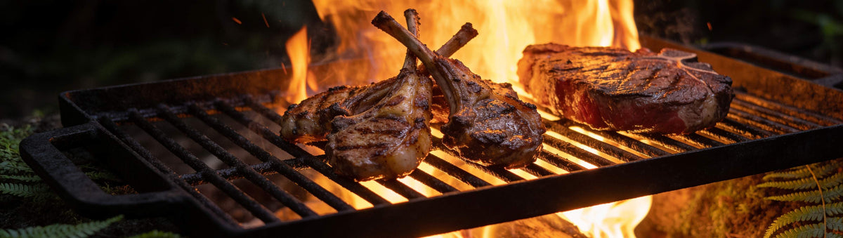 Stef the Maori Deep Bush Horopito Seasoning 200g banner — seared lamb cutlets and venison steak on a grate over a native New Zealand bush campfire