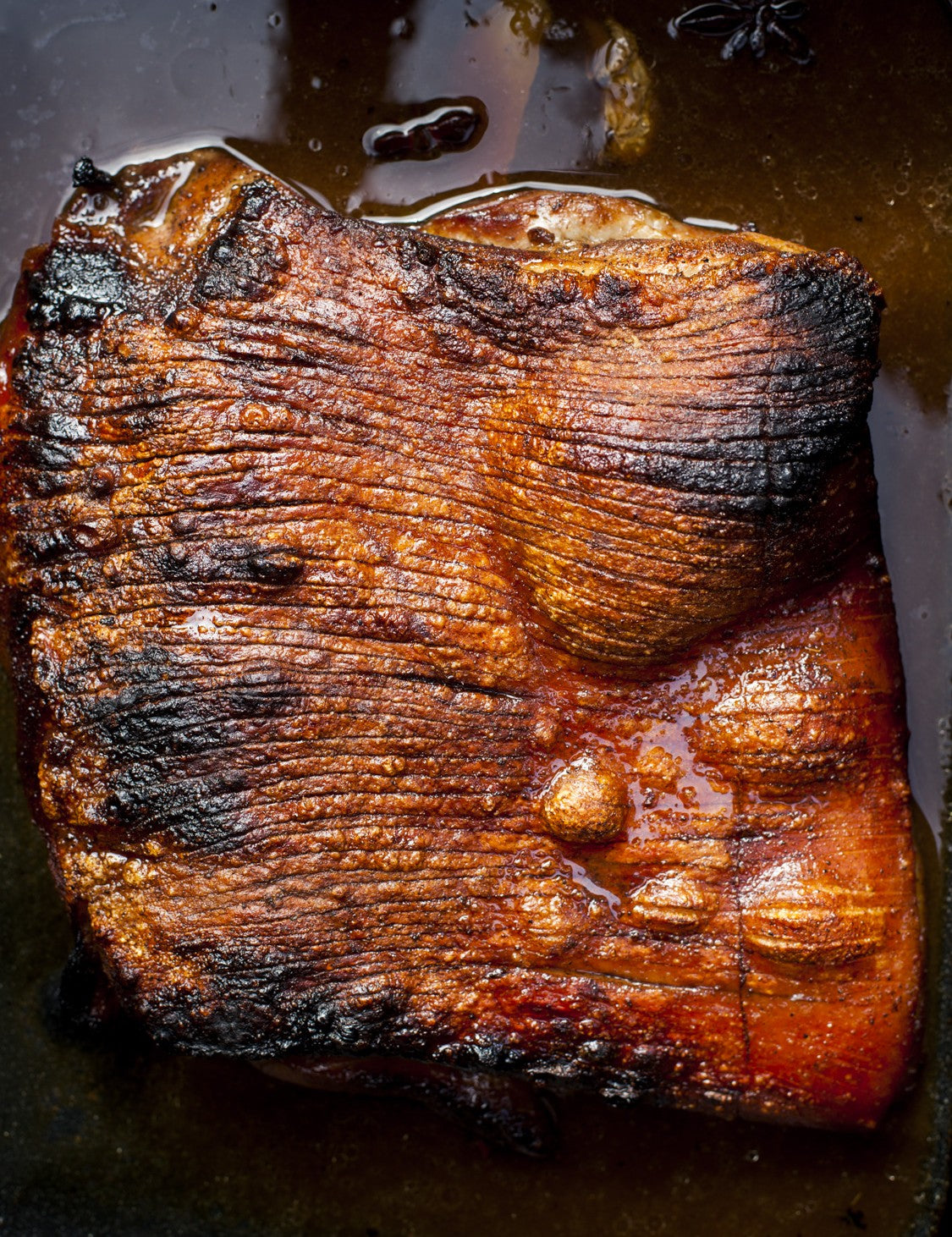 Stoked by Al Brown hardback cookbook — crackling-topped roast pork belly from the book's shoot