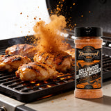 TAIPAN BBQ Bollywood Butter Chicken spiced chicken BBQ rub 175g — action shot, spiced rub cloud exploding over sizzling chicken on the grill