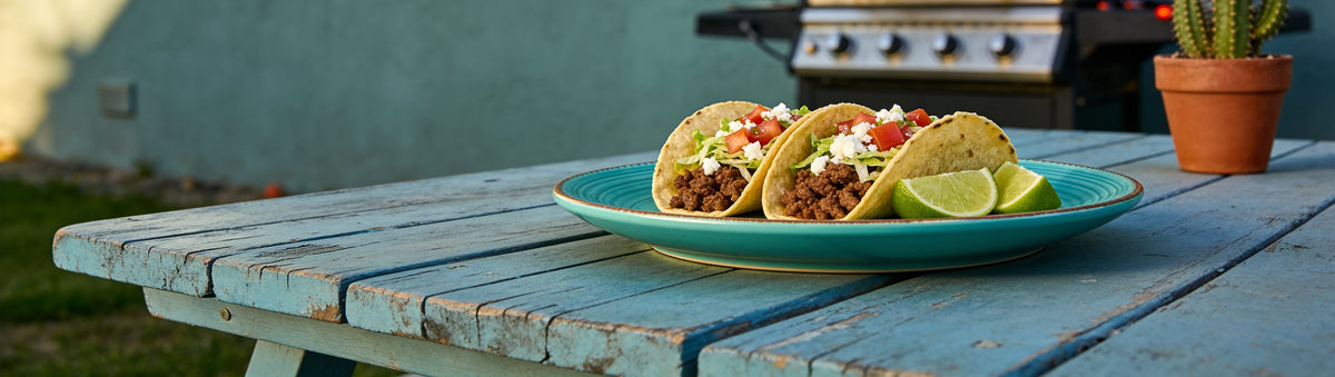 Spiced beef tacos with lime on a turquoise plate, blue timber table – Taipan BBQ Mexicana seasoning