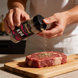 TAIPAN BBQ SPG steak & fish seasoning 300g — use shot, seasoning a raw steak on a board