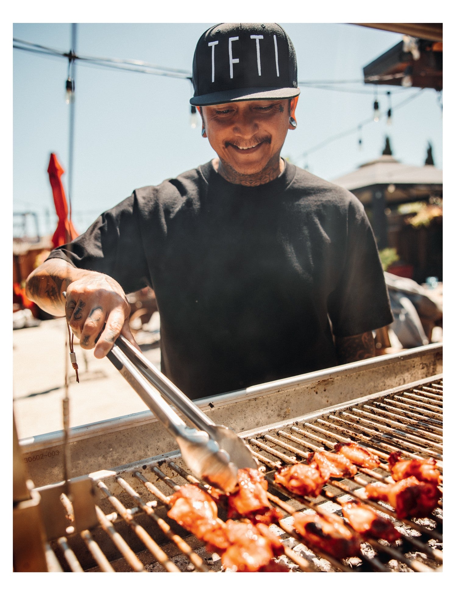 Backyard BBQ with Fire and Spice by Tony Ramirez hardback cookbook — introduction page with Tony Ramirez at the grill