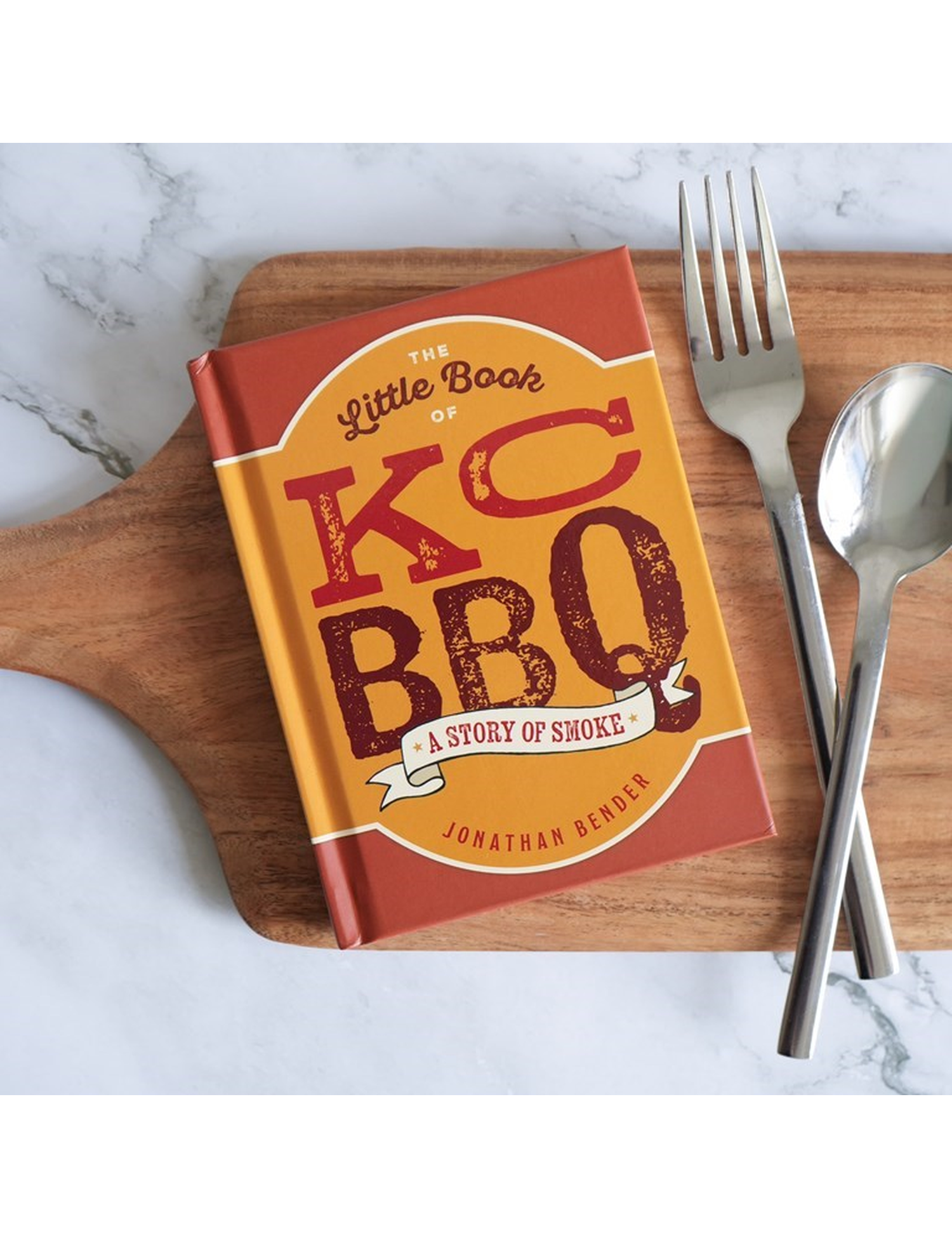 The Little Book of KC BBQ by Jonathan Bender hardback cookbook — mini hardback on a board with cutlery