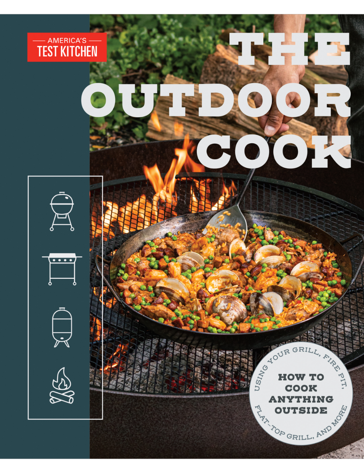 The Outdoor Cook by America's Test Kitchen paperback cookbook — front cover with paella over a fire pit