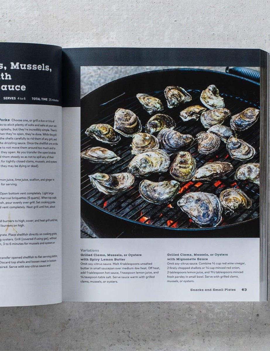 The Outdoor Cook by America's Test Kitchen paperback cookbook — grilled oysters and shellfish recipe spread