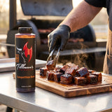 Tillman's Barbecue Competition Brew BBQ sauce — glazed burnt ends on a cutting board beside an offset smoker
