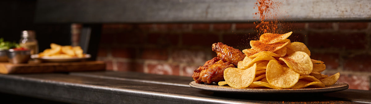 Golden chips and fried chicken under a shower of chipotle chicken salt - Uncle Mungo's Chipotle Chicken Salt