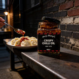 Uncle Mungo's Crispy Chilli Oil 285g crispy chilli oil — crispy chilli oil beside steamed dumplings