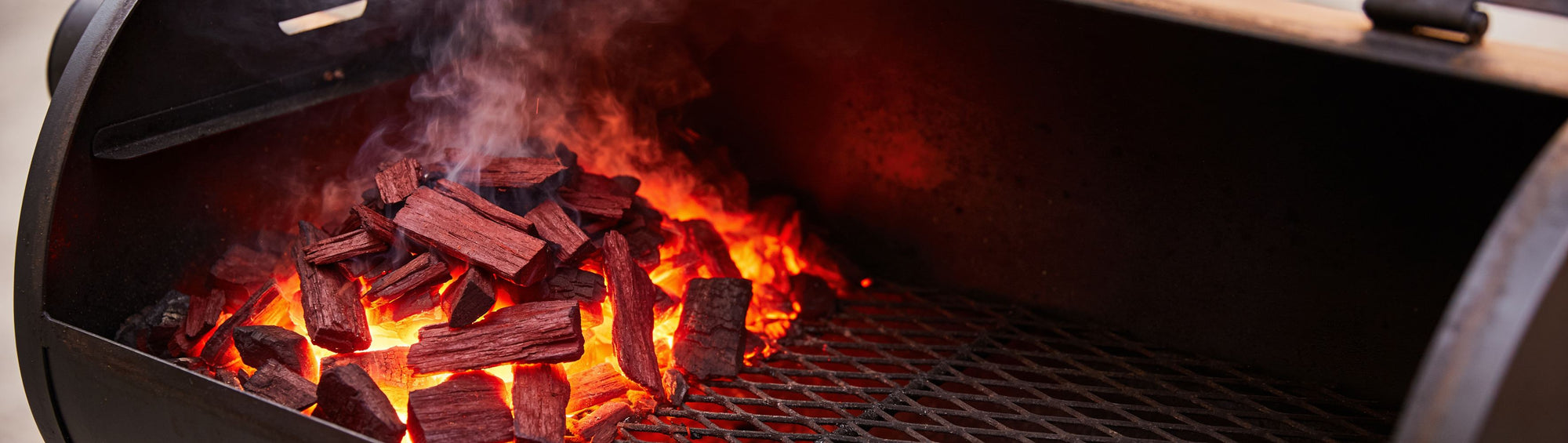 Western BBQ Products Cherry Smoking Wood Chips banner background — cherry wood chips smouldering on glowing coals