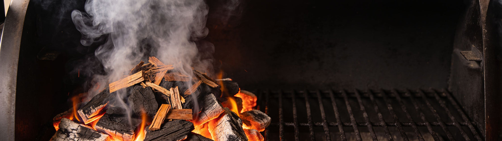 Western BBQ Products Hickory Smoking Wood Chips banner background — hickory wood chips smouldering on glowing coals