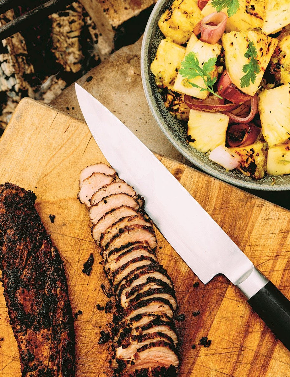 Wood, Fire & Smoke by Michael Smith hardback cookbook — coffee spice-rubbed pork tenderloin sliced on a board