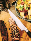 Wood, Fire & Smoke by Michael Smith hardback cookbook — coffee spice-rubbed pork tenderloin sliced on a board