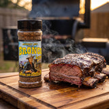 Heavenly Hell Bronco Layne beef rub 150g — shaker beside smoked beef ribs with a dark peppery bark on a board